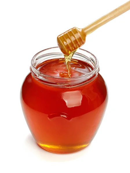 Ξύλινη κουτάλα με το βάζο με μέλι. — Φωτογραφία Αρχείου