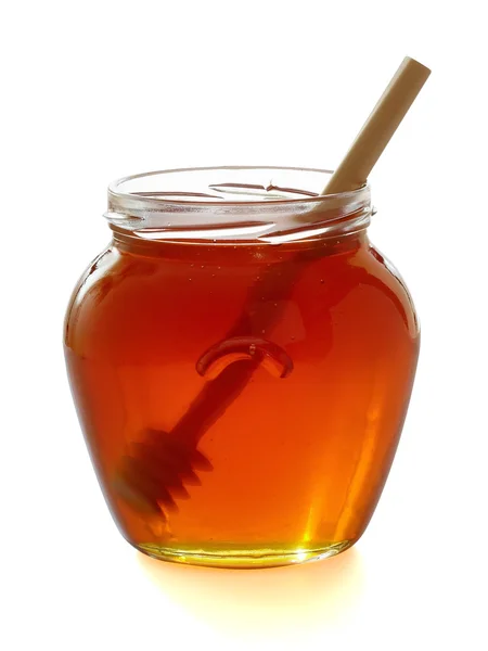 Wooden dipper with jar of honey. — Stock Photo, Image