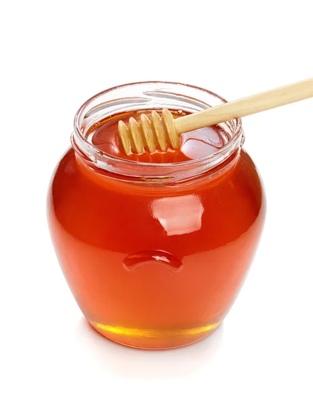 Wooden dipper with jar of honey. — Stock Photo, Image