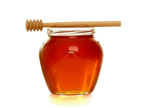 蜂蜜の瓶と木製のディッパー. — ストック写真