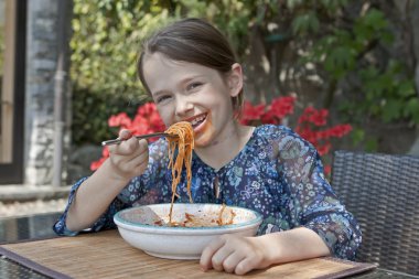 Girl is eating spaghetti clipart