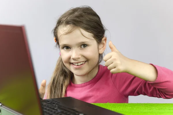 Seven-year old girl with laptop — Stock Photo, Image