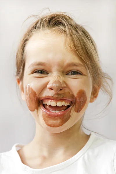 Girl with chocolate on her face — Stock Photo, Image