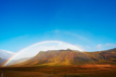 Beautiful rainbow over the mountains, North Fjords Iceland clipart