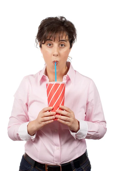 Surprised young woman drinking — Stock Photo, Image