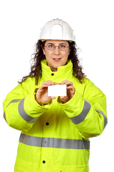 Female construction worker holding one blank card — Stock Photo, Image