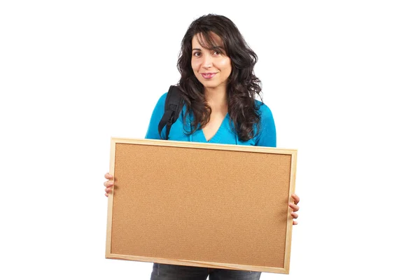Mulher estudante segurando o corkboard vazio — Fotografia de Stock