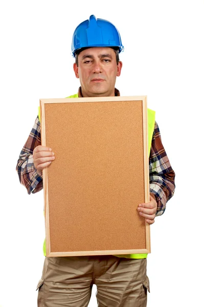 Bauarbeiter hält die leere Korkplatte — Stockfoto