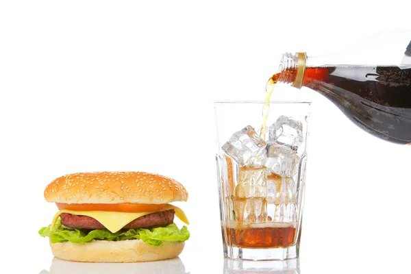 Cheeseburger and pouring soda — Stock Photo, Image