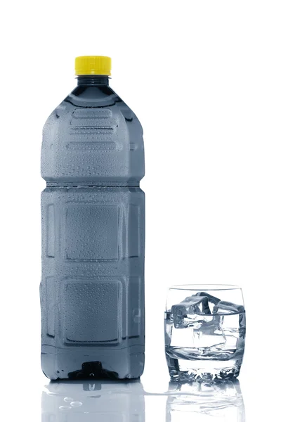 Botella y vaso de agua mineral con gotitas —  Fotos de Stock