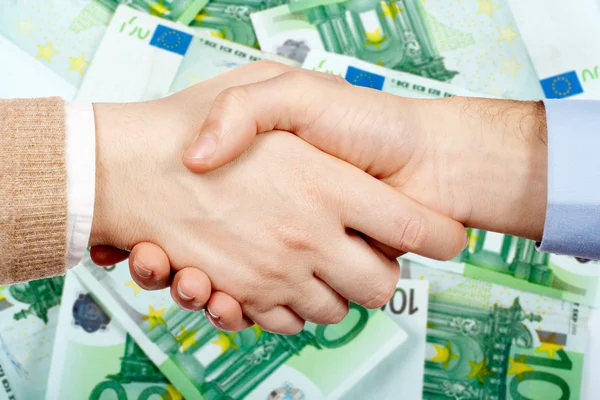 Handshake a peníze — Stock fotografie