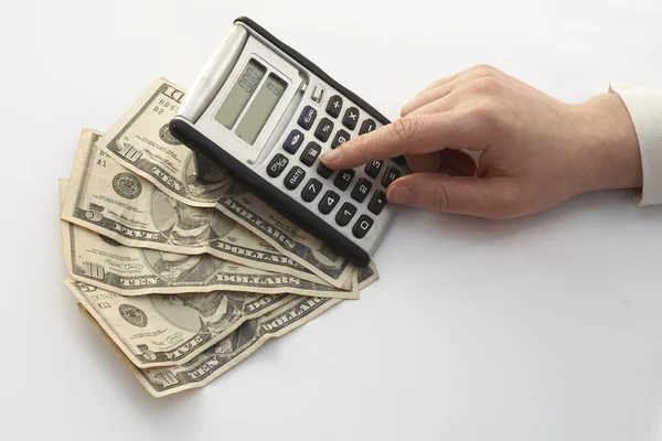 Calculating over a fan of money — Stock Photo, Image