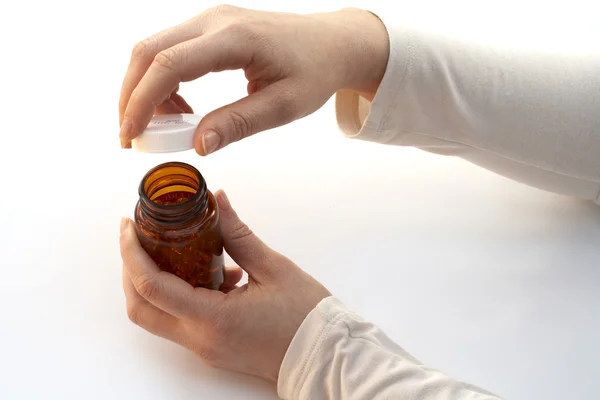 Opening a medicine bottle — Stock Photo, Image