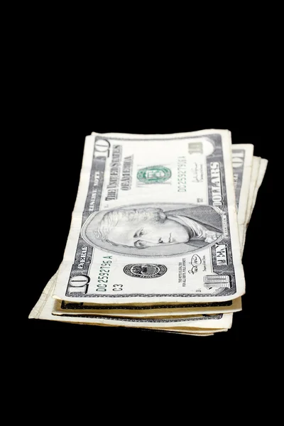 Pilha de notas de dólar, isolado em fundo preto — Fotografia de Stock