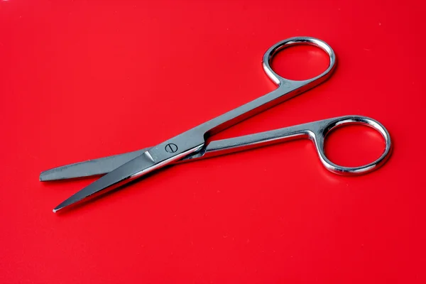 Scissors on a red background — Stock Photo, Image
