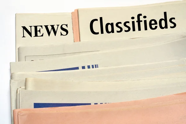 Stacked classifieds newspapers — Stock Photo, Image