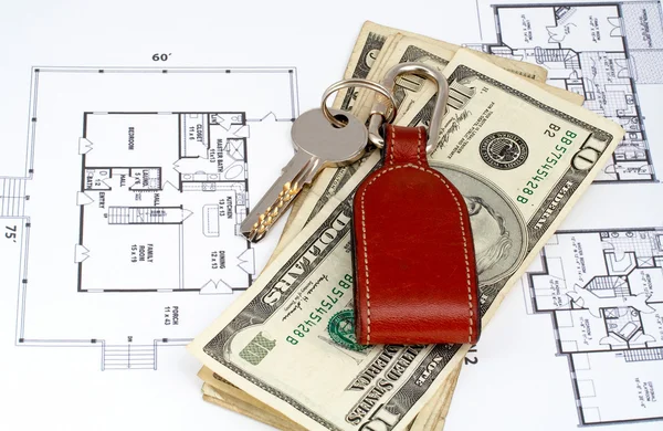 Key and money on home plan — Stock Photo, Image
