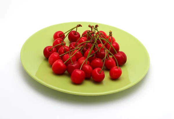 Cherries on the green plate — Stock Photo, Image