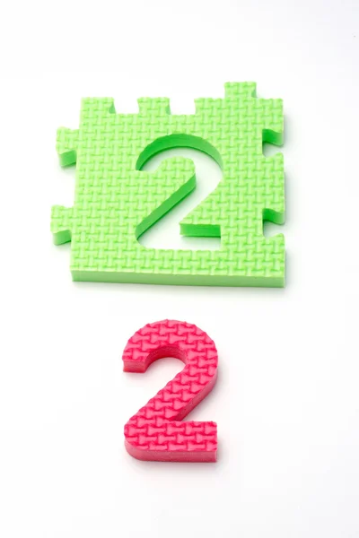 Két szám puzzle szőnyeg. Az első (kis Dof összpontosítani) — Stock Fotó