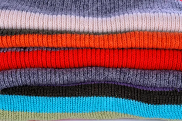 stock image Several colors pullovers stack