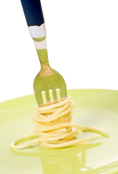 Spaghetti gerold op een groene schotel — Stockfoto