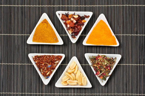 Assortment of spices over a bamboo mat — Stock Photo, Image