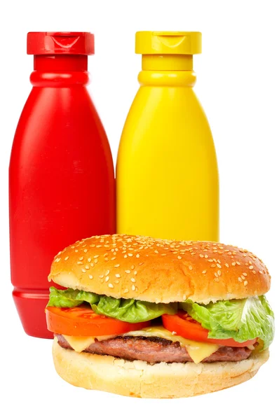 Burger with mustard and ketchup bottles — Stock Photo, Image