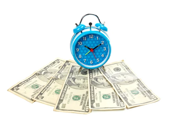 Alarm clock over a fan of money — Stockfoto