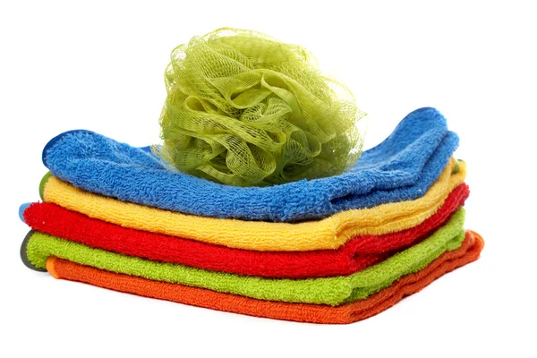 Multicolour towels stacked and body sponge — Stock Photo, Image