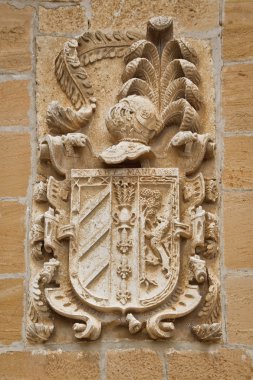 Carved stone coat of arms on the wall clipart