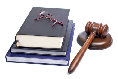 Wooden gavel, glasses and law books clipart