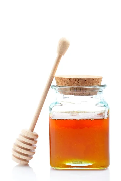 Tarro de miel y drizzler de madera — Stockfoto
