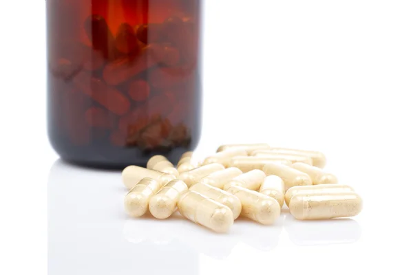 Capsules near the flask — Stock Photo, Image