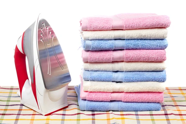 Electric iron and towels stacked — Stock Photo, Image