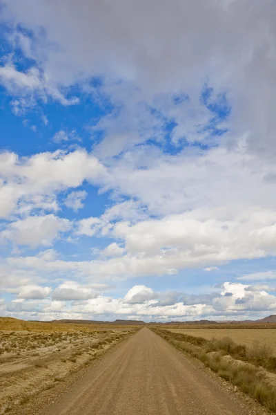 Strada solitaria sotto cielo nuvoloso — Foto Stock