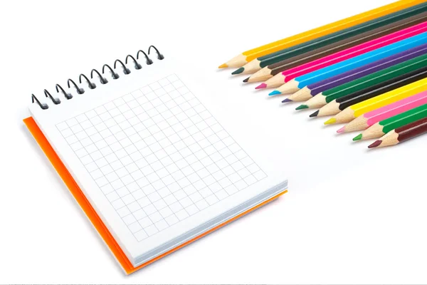 Blank notebook and coloured pencils — Stock Photo, Image