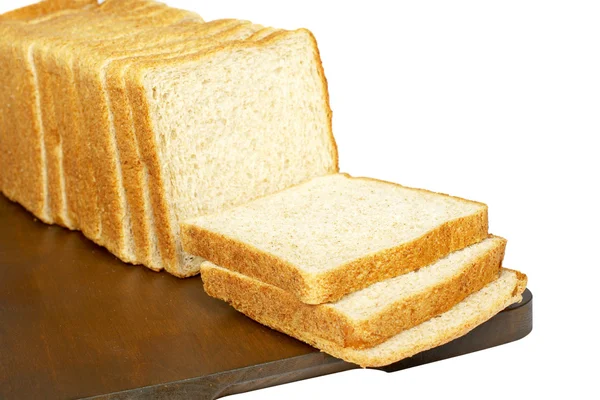 Slices of bread on plank — Stock Photo, Image