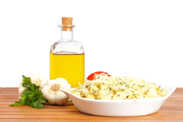 Pasta, parsley, garlics and oil bottle — Stock Photo, Image