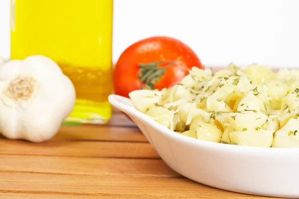 Pasta, parsley, garlics and oil bottle — Stock Photo, Image