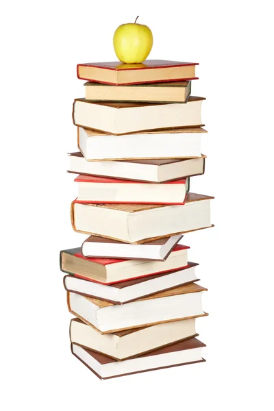 Yellow apple on pile of books — Stock Photo, Image