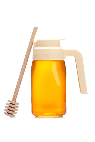 Honey pitcher and wooden drizzler — Stock Photo, Image