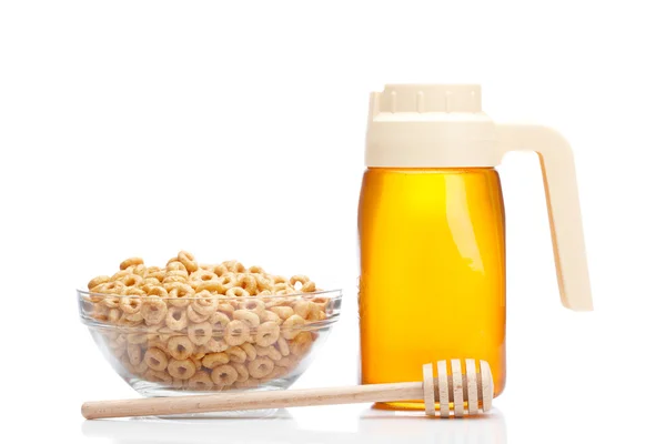 Honigkrug und Schale mit Cheerios — Stockfoto