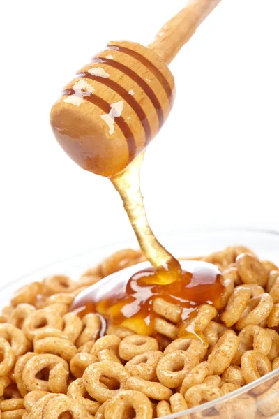 Gieten honing op cornflakes — Stockfoto