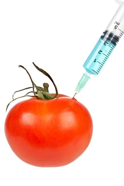 Tomato with syringe inserted — Stock Photo, Image