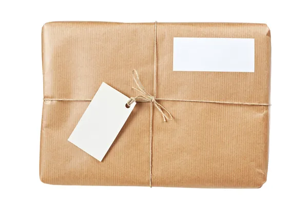 Paquete marrón con etiquetas en blanco —  Fotos de Stock