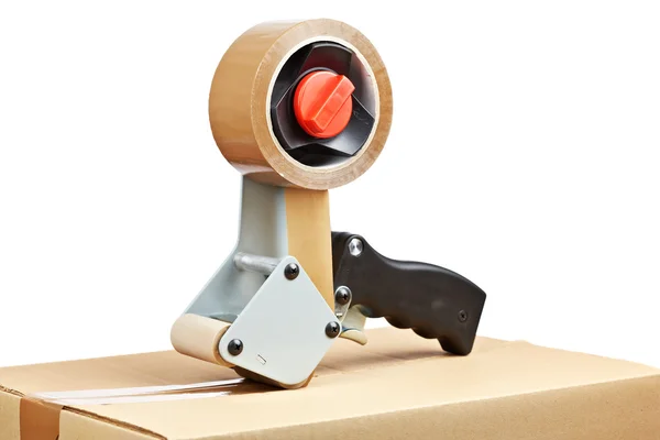 Packaging tape dispenser and shipping box — Stock Photo, Image
