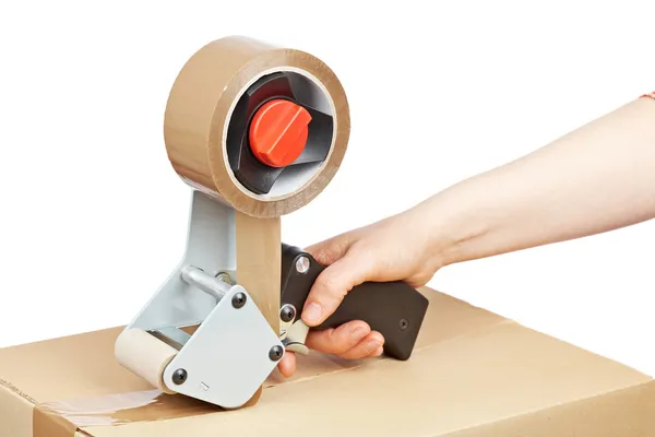 Packaging tape dispenser and shipping box — Stock Photo, Image