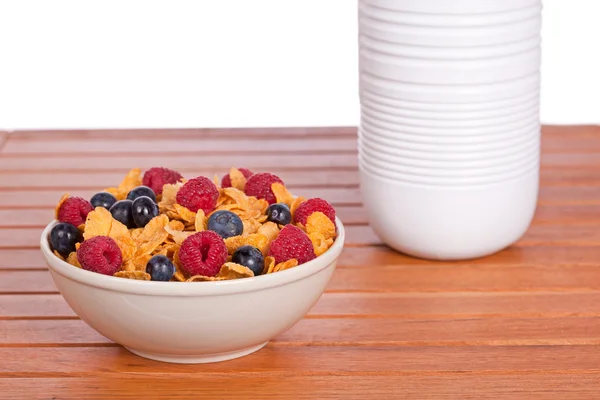 Cornflakes with fruits and milk bottle — Stock Photo, Image