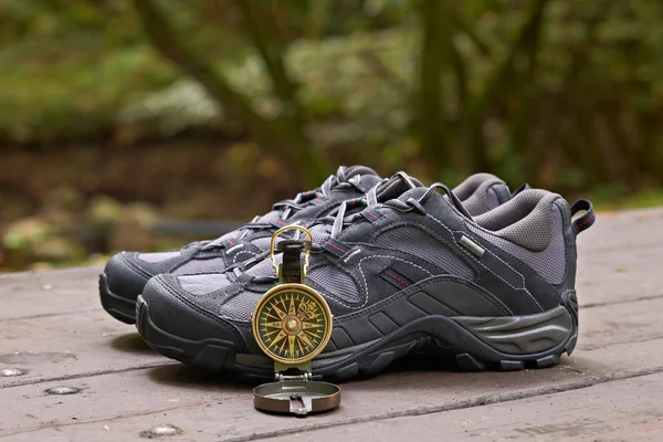 Hiking boots and compass — Stock Photo, Image