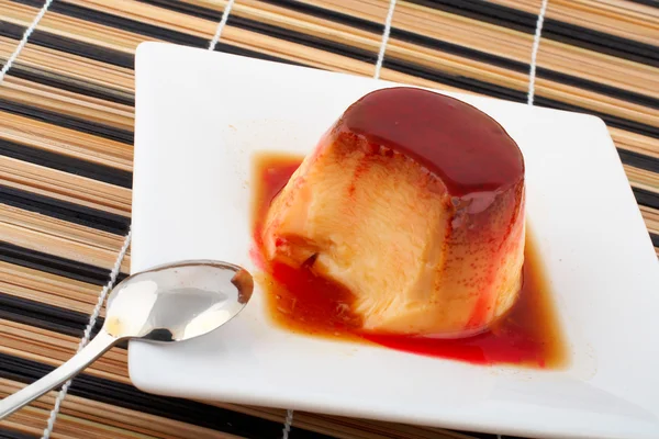 Vanilj grädde och sockerkulör dessert med sked på vita skålen — Stockfoto
